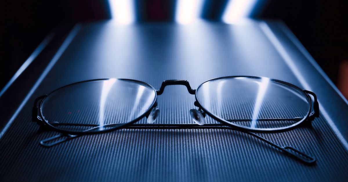 Close-up of blue-light-blocking glasses with a reflective blue tint