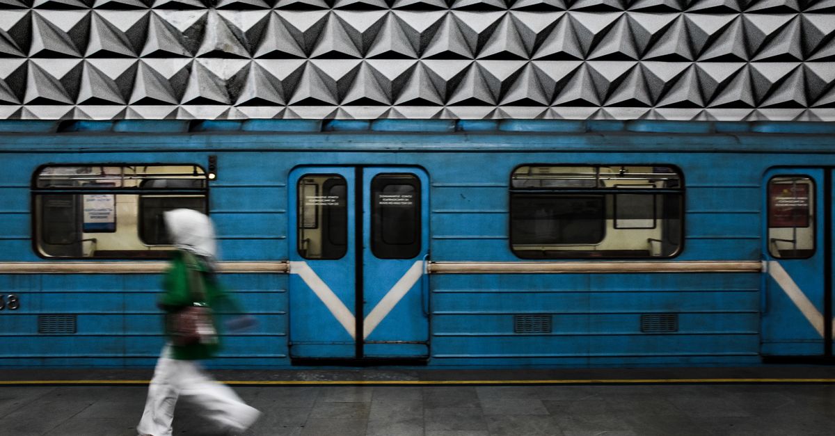 A commuter walking along a train platform