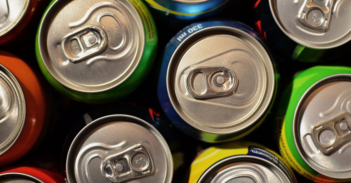 Close-up of colourful beverage cans arranged closely together, showcasing various colours.