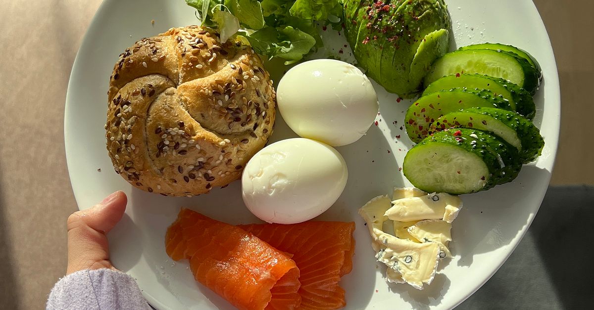 A plate of protein-rich breakfast food including eggs, salmon and avocado