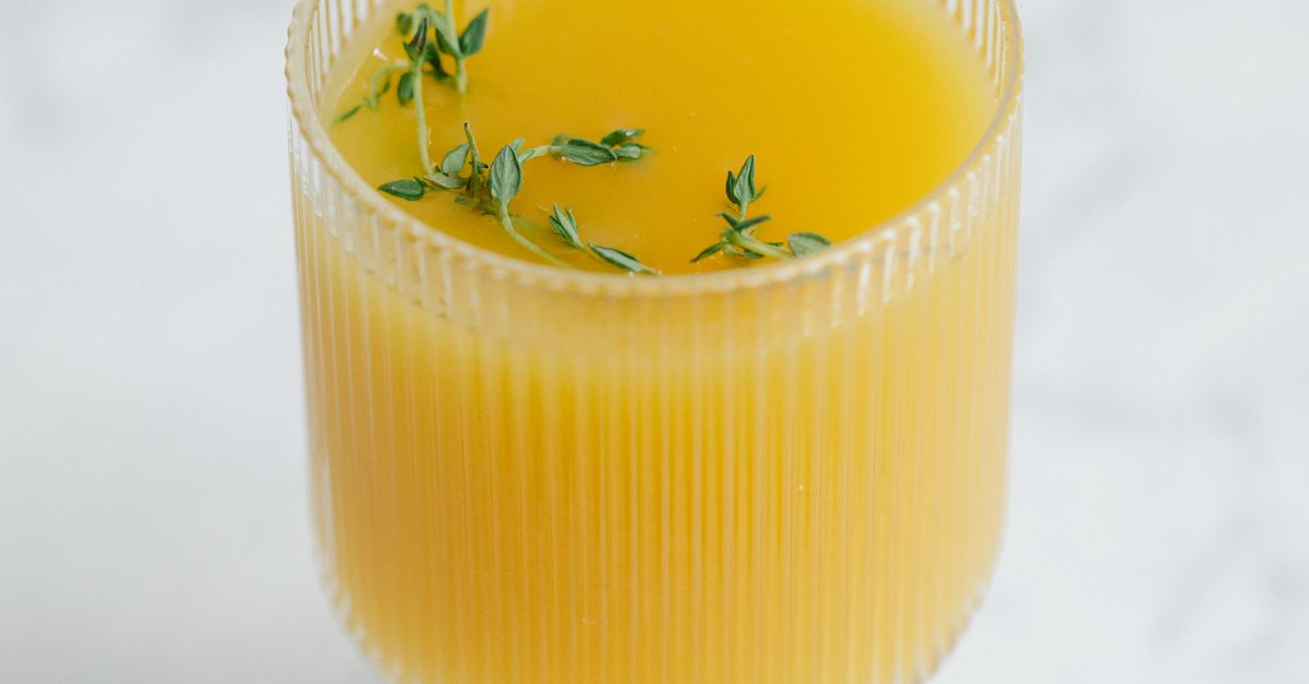 A glass of fresh juice garnished with herbs, an alcohol-free drink