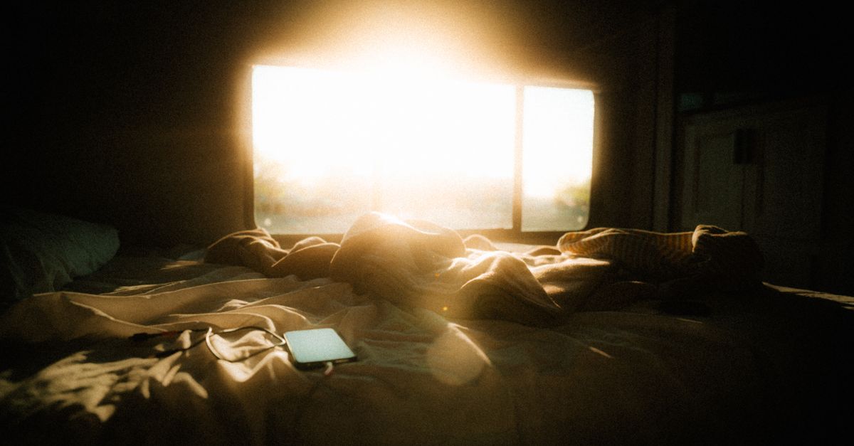 Gentle morning sunlight filling a cozy bedroom at dawn