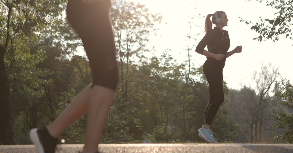 A person jogging at an easy, conversational pace outdoors